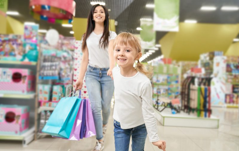 Мама покупает детские игрушки на распродаже в Черную пятницу-2021 в Днепре.